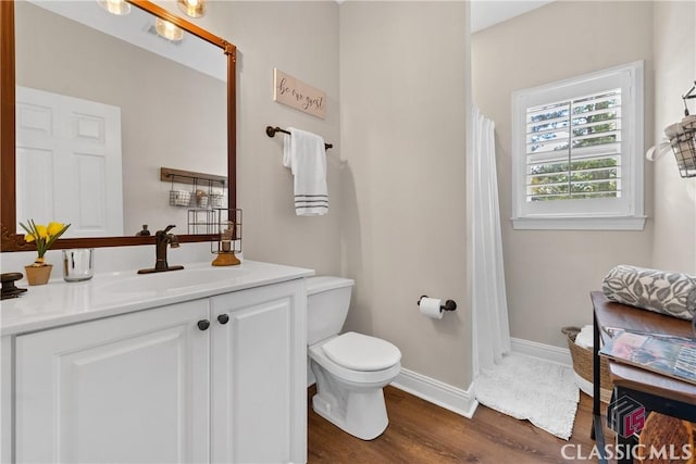 bathroom featuring vanity, hardwood / wood-style floors, and toilet