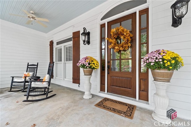 doorway to property featuring covered porch and ceiling fan