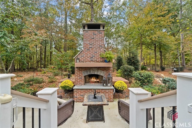 view of patio featuring an outdoor brick fireplace