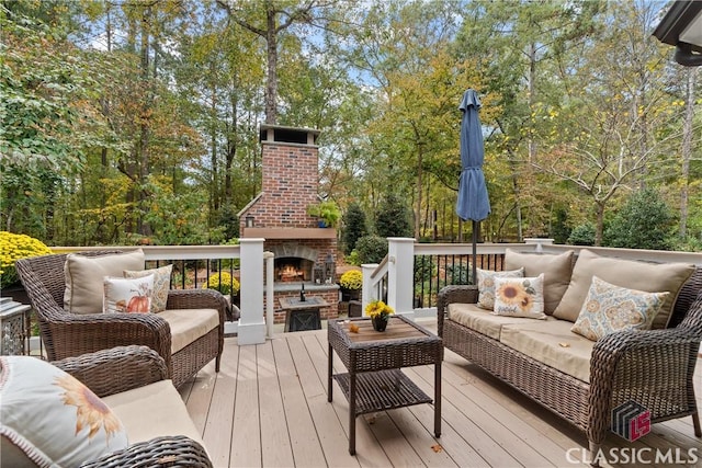 wooden deck with an outdoor living space with a fireplace