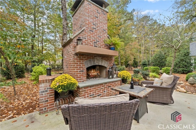 view of patio / terrace featuring an outdoor living space with a fireplace