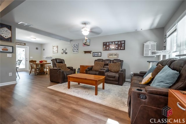 living room with hardwood / wood-style flooring and ceiling fan