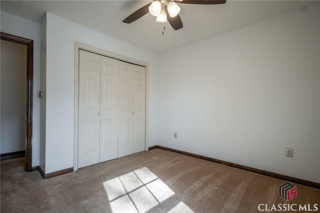 unfurnished bedroom featuring ceiling fan, carpet floors, and a closet