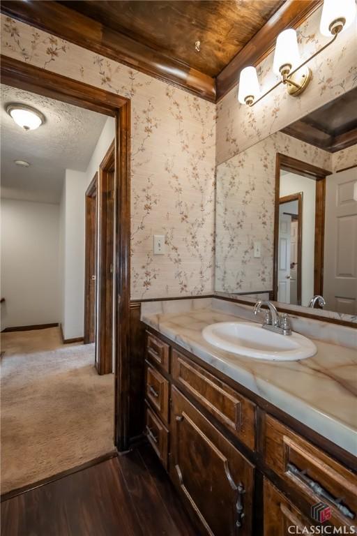 bathroom with vanity, hardwood / wood-style floors, and a textured ceiling