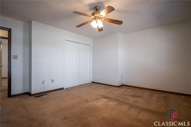 unfurnished bedroom featuring a textured ceiling, carpet floors, a closet, and ceiling fan