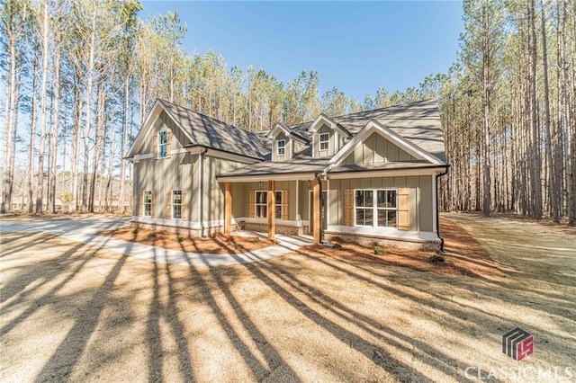 view of front of home with a porch and a front yard