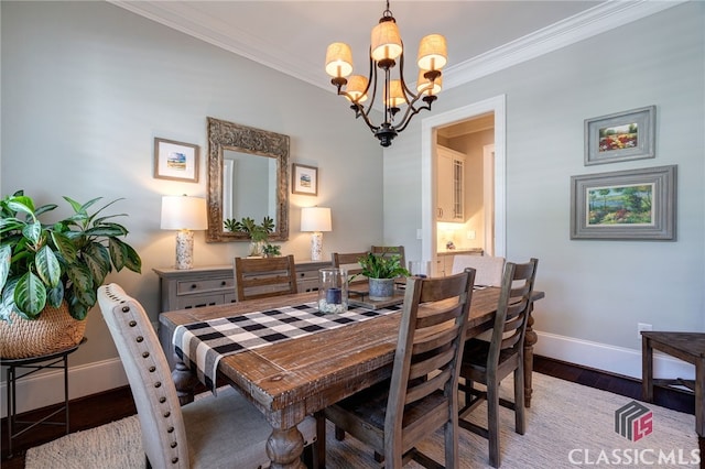 dining area with crown molding, dark hardwood / wood-style floors, and a notable chandelier