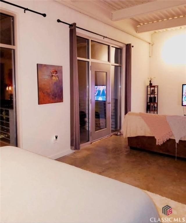 bedroom featuring beamed ceiling and access to exterior