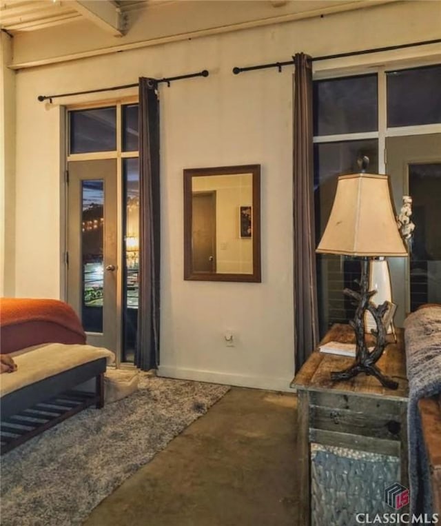 bedroom with access to exterior and concrete flooring