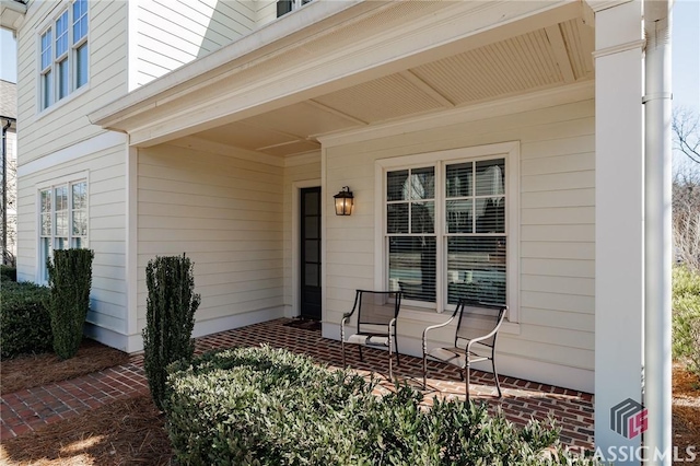 view of exterior entry with a porch