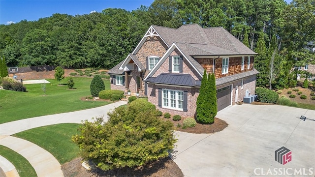 craftsman-style house with a garage and a front lawn