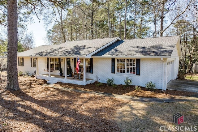 ranch-style house with a porch and a garage