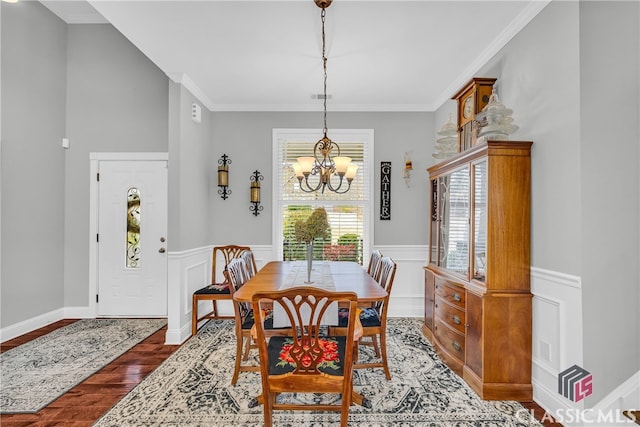 dining room featuring an inviting chandelier, crown molding, and dark hardwood / wood-style floors