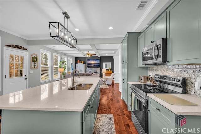 kitchen featuring appliances with stainless steel finishes, sink, and green cabinets