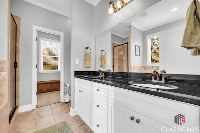 bathroom featuring tile patterned floors, ornamental molding, an enclosed shower, and vanity