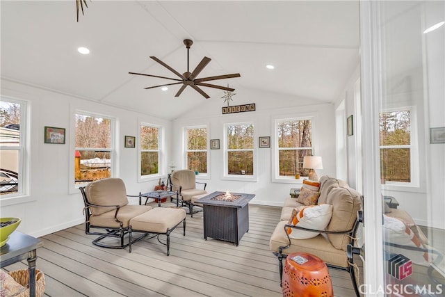 sunroom / solarium featuring lofted ceiling with beams, a wealth of natural light, and ceiling fan