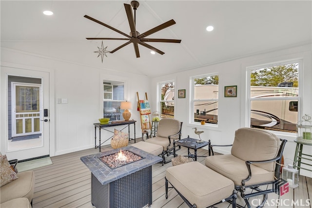 living room with lofted ceiling, light hardwood / wood-style flooring, and ceiling fan