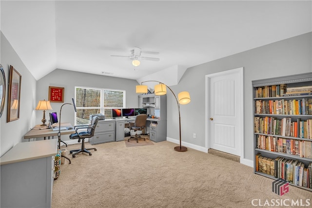 home office featuring lofted ceiling, light colored carpet, and ceiling fan