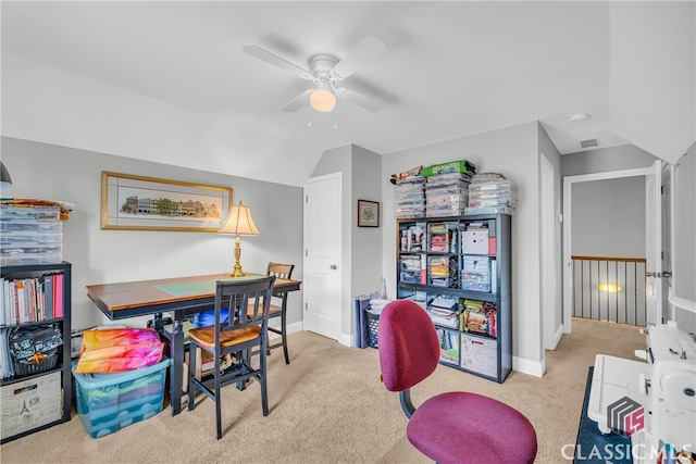 office area with ceiling fan, light colored carpet, and vaulted ceiling