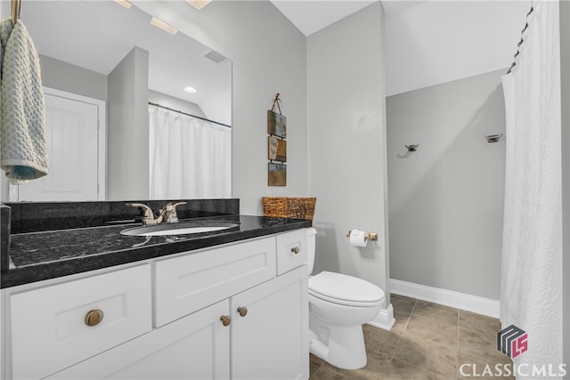 bathroom with vanity, tile patterned floors, and toilet