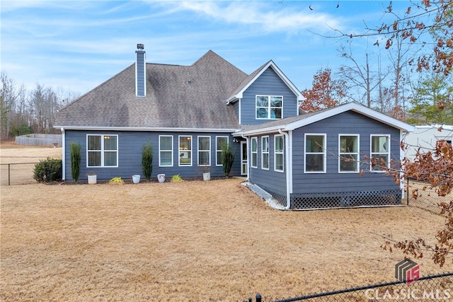 rear view of property with a lawn