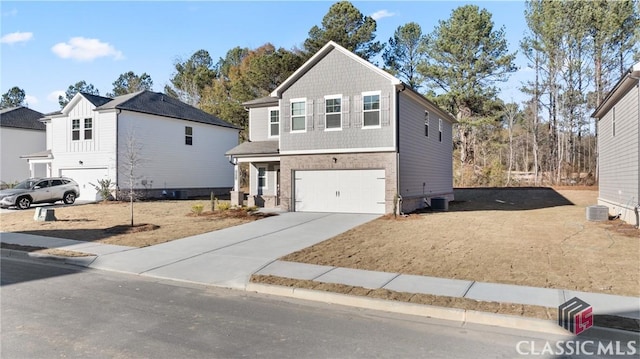 view of front property featuring a garage and central air condition unit