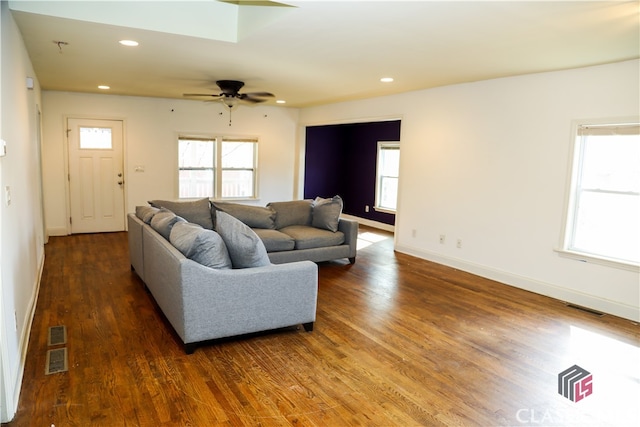 living room with ceiling fan, dark hardwood / wood-style floors, and a wealth of natural light