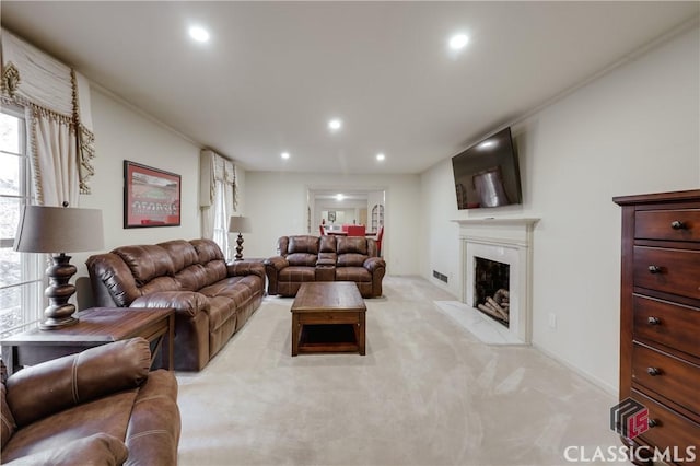 living room featuring crown molding and light colored carpet