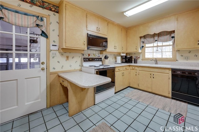 kitchen featuring sink, light tile patterned floors, light brown cabinets, and black appliances