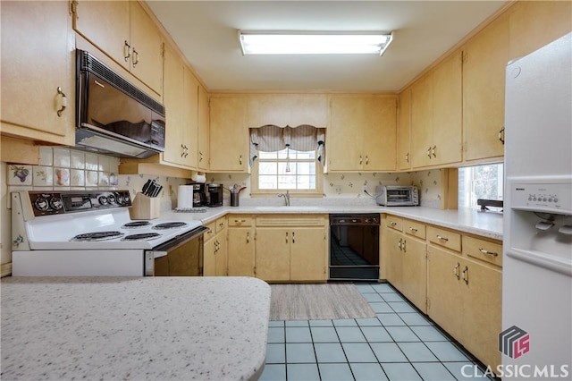 kitchen with light brown cabinetry, tasteful backsplash, sink, light tile patterned floors, and black appliances