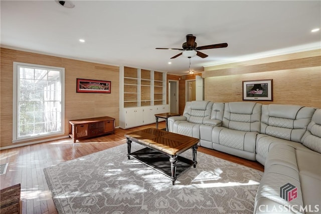 living room with ceiling fan and light hardwood / wood-style flooring