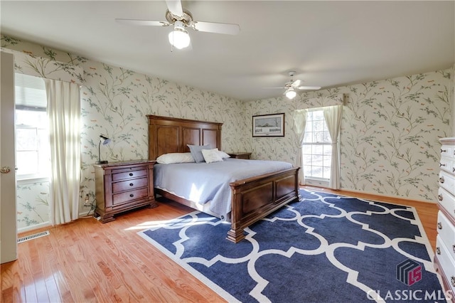 bedroom with light hardwood / wood-style flooring and ceiling fan