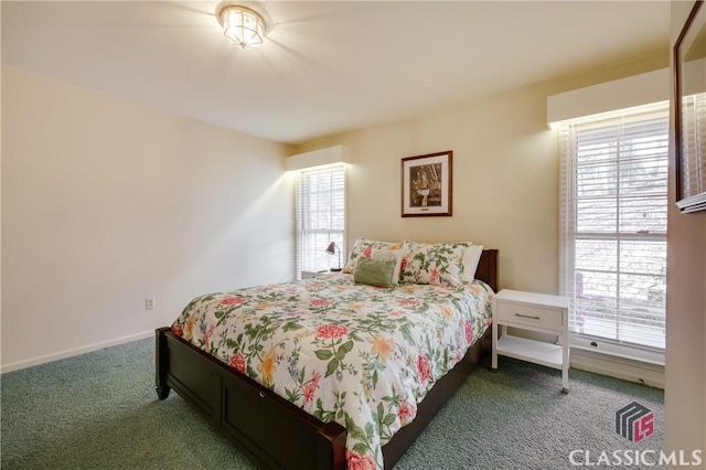 carpeted bedroom featuring multiple windows