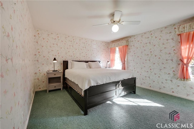 unfurnished bedroom featuring dark carpet and ceiling fan