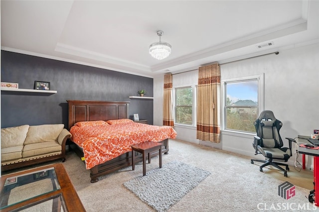 carpeted bedroom with a tray ceiling, crown molding, and a notable chandelier