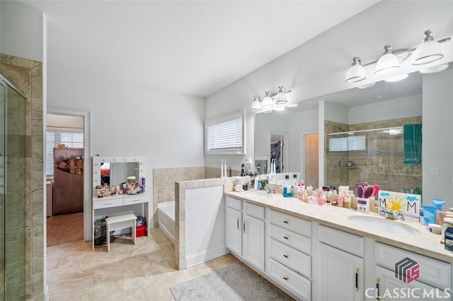 bathroom with shower with separate bathtub and vanity