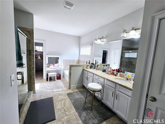 bathroom featuring plus walk in shower and vanity