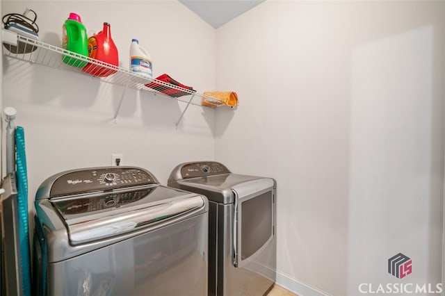 clothes washing area with washing machine and dryer