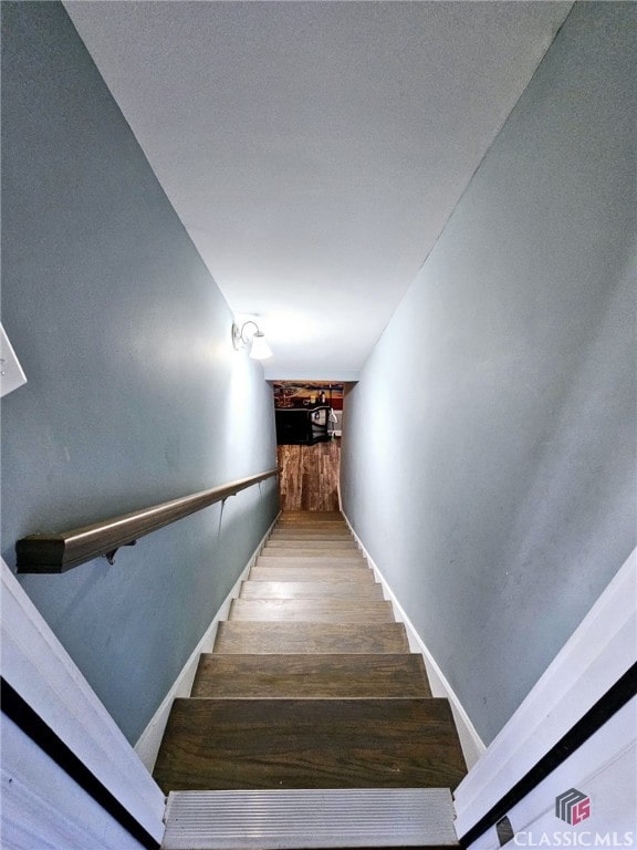 stairway with hardwood / wood-style floors