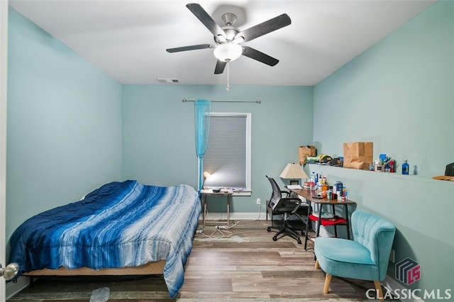 bedroom featuring hardwood / wood-style flooring and ceiling fan