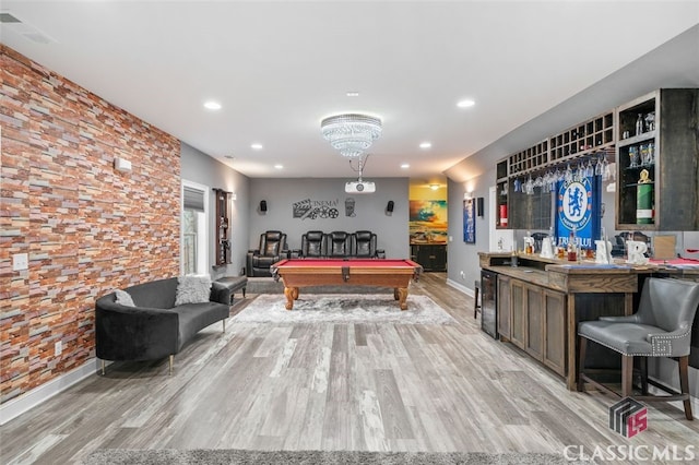 playroom with wine cooler, light hardwood / wood-style flooring, billiards, and bar area