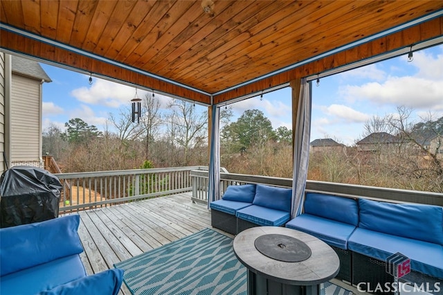 sunroom / solarium featuring wood ceiling