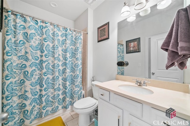 bathroom featuring vanity, toilet, and tile patterned flooring