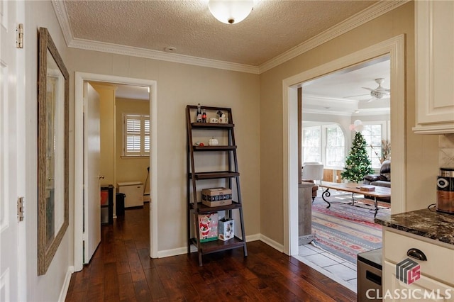 hallway featuring ornamental molding, dark wood-type flooring, and a textured ceiling