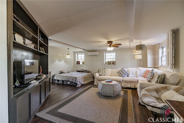 bedroom featuring dark hardwood / wood-style floors, a wall mounted air conditioner, and ceiling fan