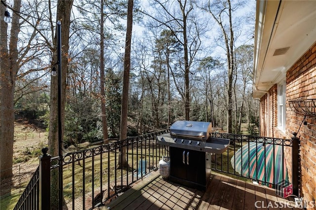 wooden terrace with area for grilling