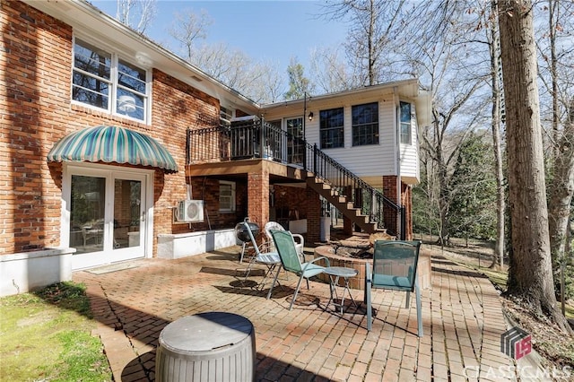 rear view of property with a patio area and french doors