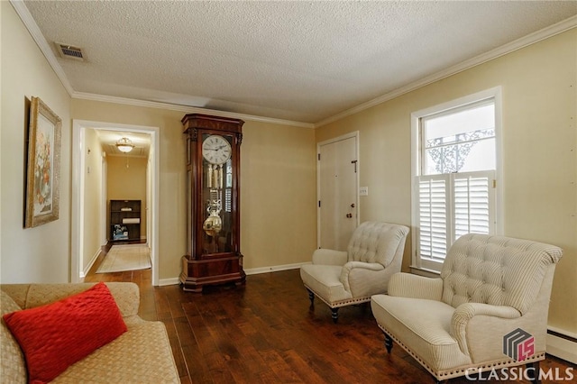 living area featuring ornamental molding, dark hardwood / wood-style flooring, a textured ceiling, and a baseboard heating unit