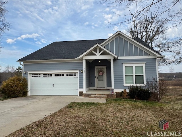 view of front of home with a garage and a front lawn