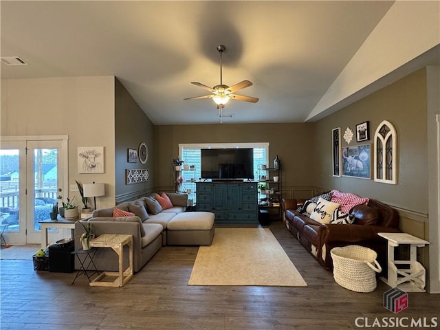 living room with lofted ceiling, a healthy amount of sunlight, and dark wood-type flooring